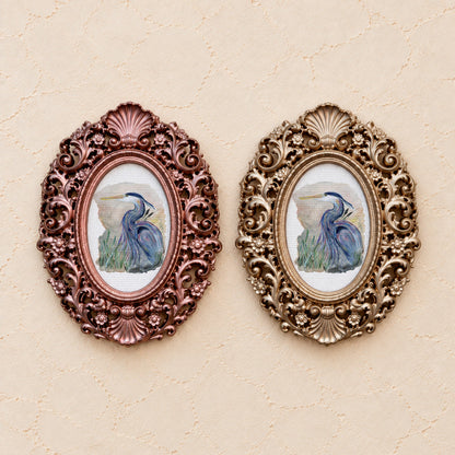 Blue Heron Portrait, gold and rose gold side by side