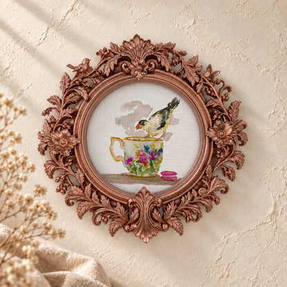 Goldfinch on a Teacup round framed art print, rose gold baroque frame